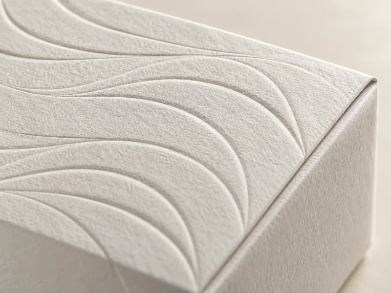Raised waves on ivory paper wrapping a rigid box