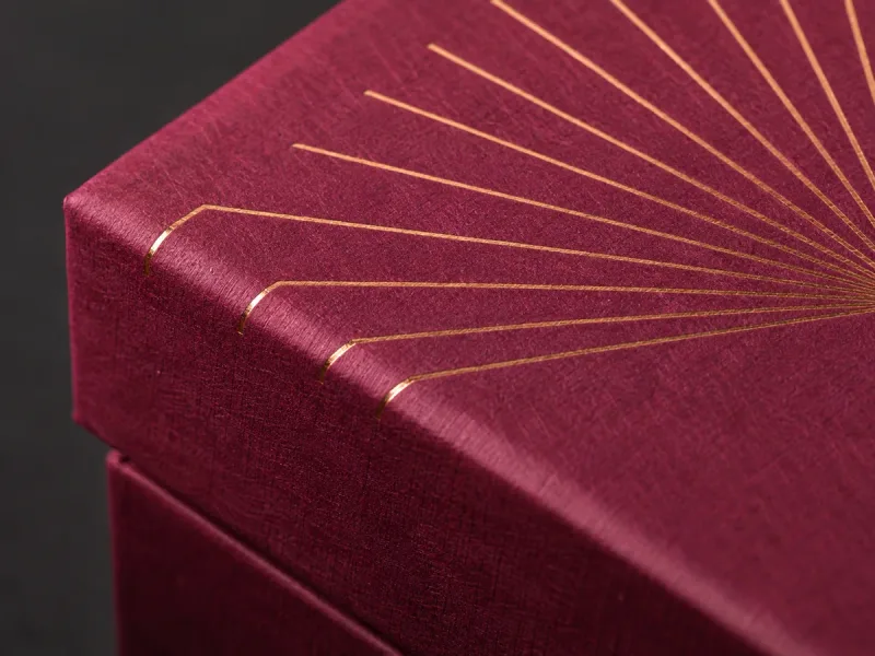 Copper foil fan lines across a fuchsia rigid box corner