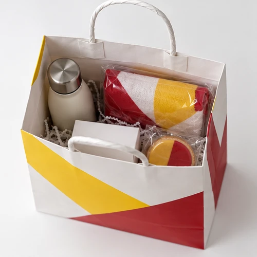 Custom client welcome kit packaging — Twisted-paper handle bag — Packed products