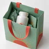 Sealed supplement bottle — Ribbon-handle paper bag