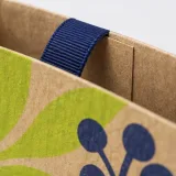Custom festive confectionery packaging — Ribbon-handle paper bag — Paper & finish